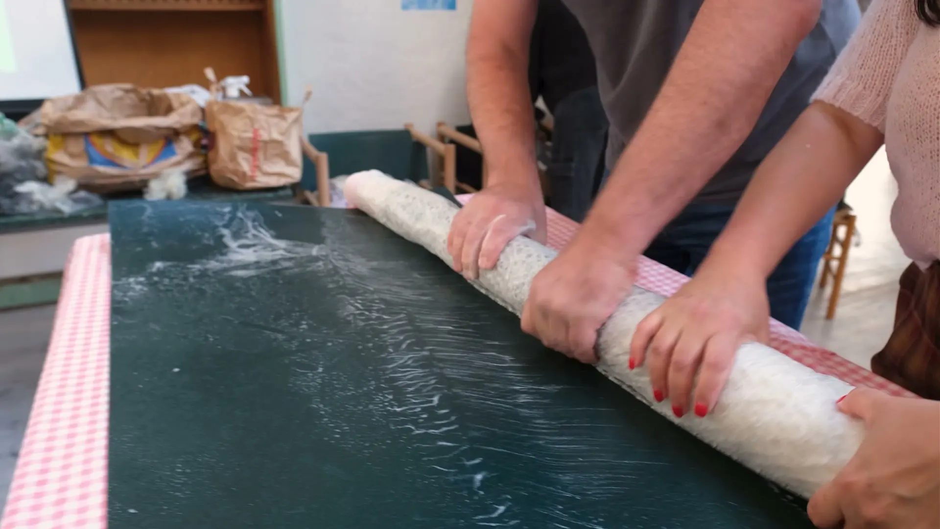 Rolling the felted wool around the pole