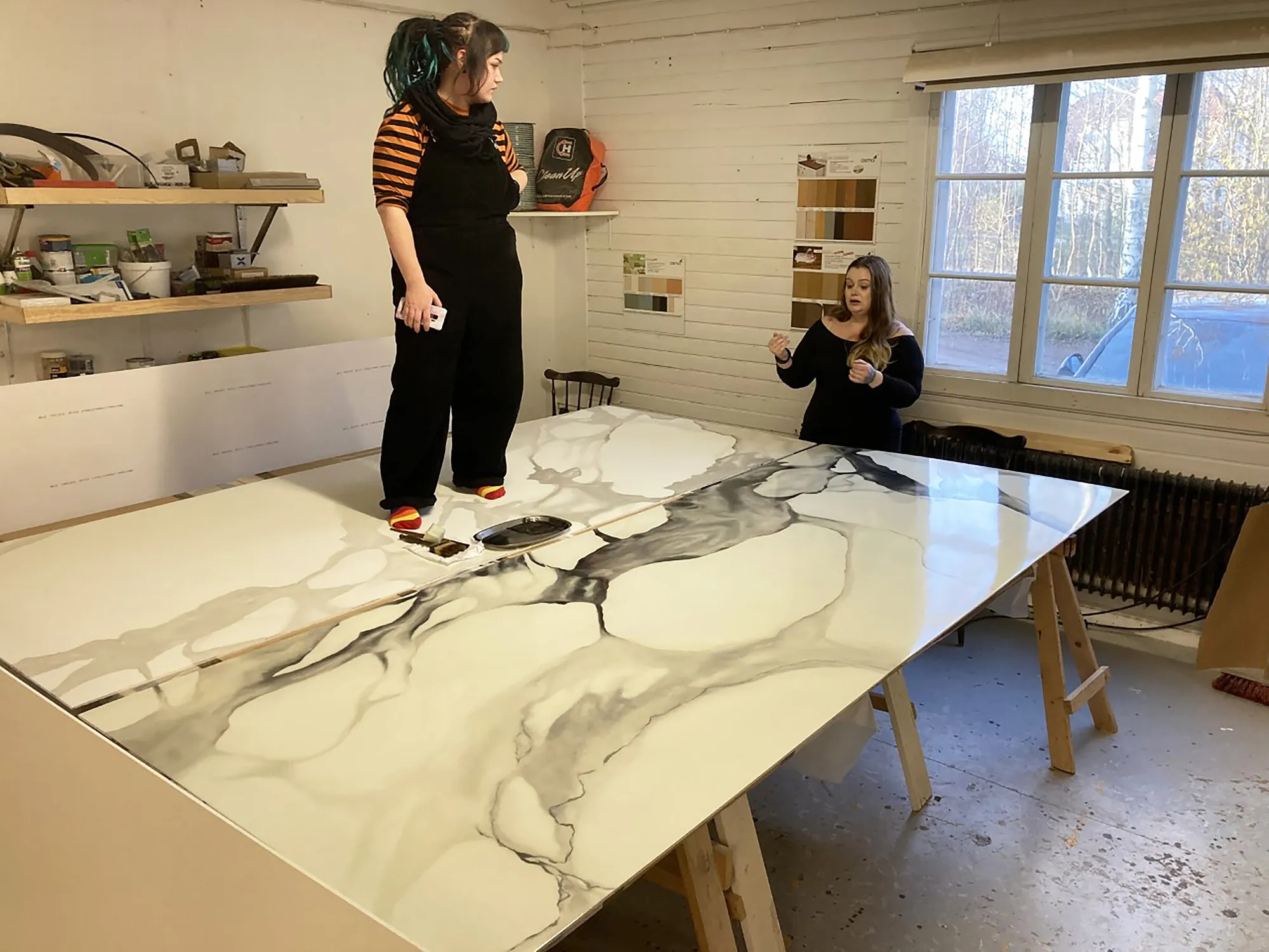 Students painting the roof sheets as faux marble